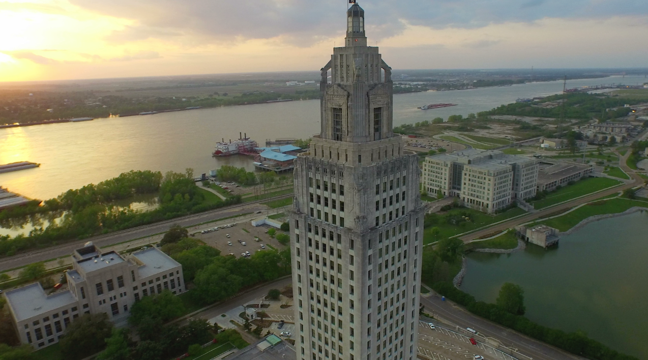 0008 Epic aerial drone arc out of Louisiana State Capitol 1 to nice sunset on Mississippi river