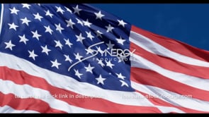 1282 fast pan of american flag slow motion with blue sky
