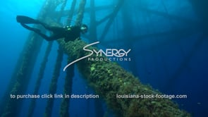 0476 scuba diver observing underwater oil rig gas platform ecosystem