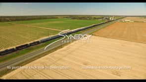 0693 Epic aerial drone view train traveling thru farmland