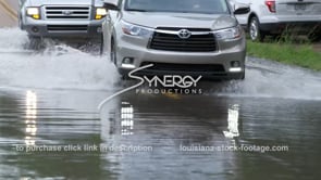 0363 trucks cars driving thru flood water CU after flooding