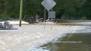 0318 couple in boat escaping flooding flood water overflowing river