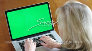 1851 business lady types on laptop green screen