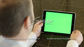 1857 man watches video on iPad green screen replacement